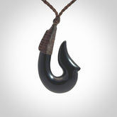 This piece is a hand carved black jade matau pendant, otherwise known as a traditional fish hook necklace.